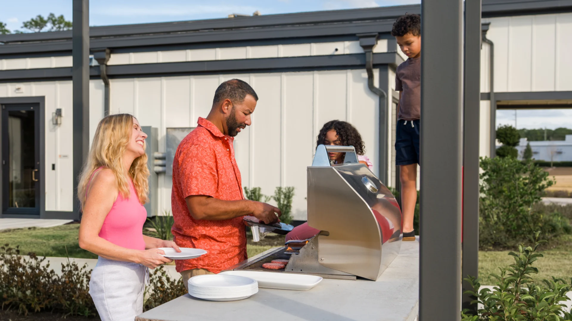 Residents grilling out at a Pointe Grand community