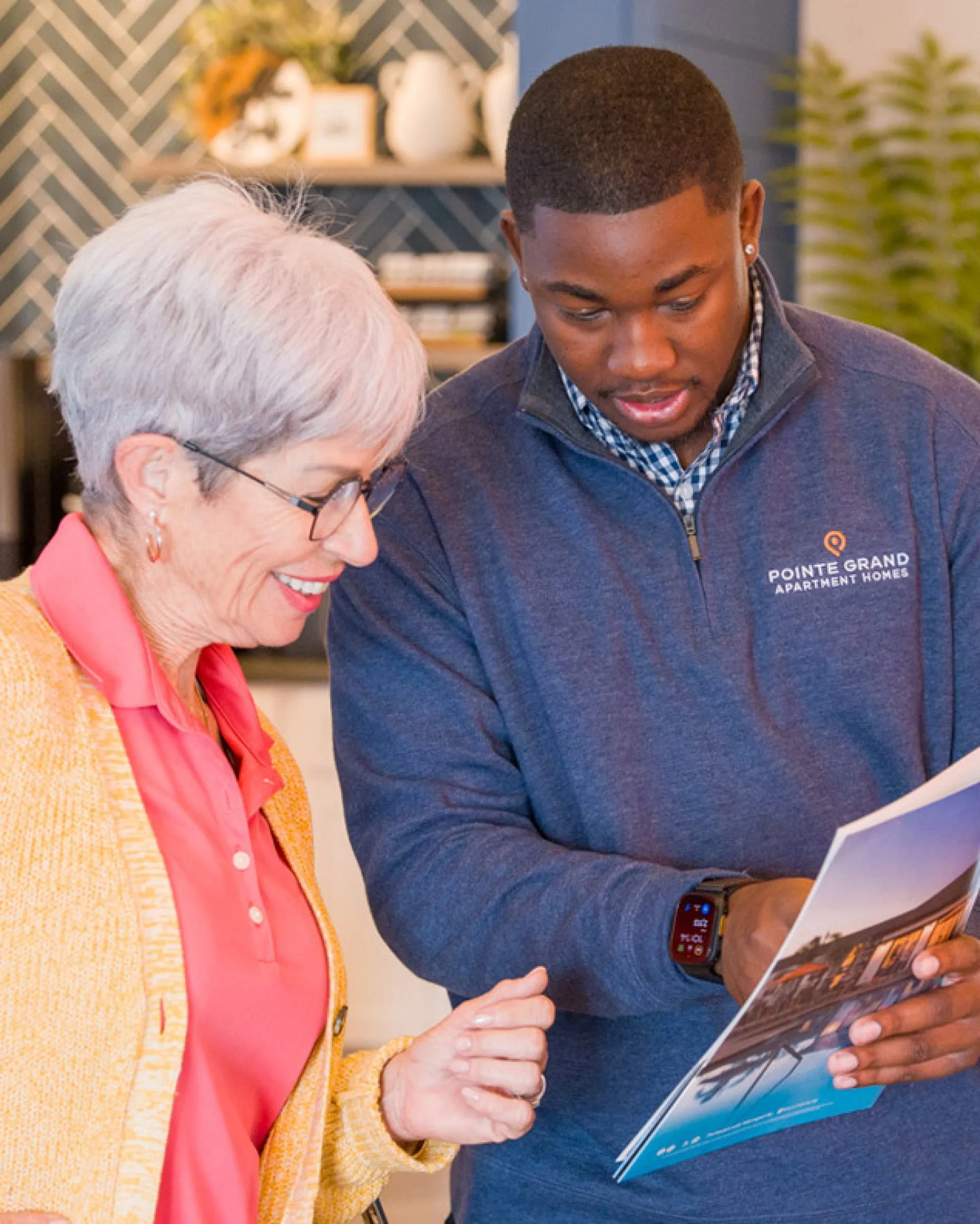 A leasing team member welcoming residents at a Pointe Grand community