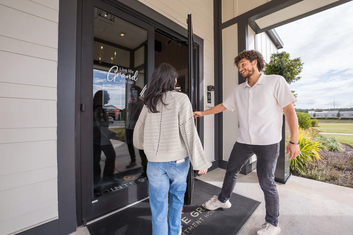 A leasing team member welcoming residents at a Pointe Grand community
