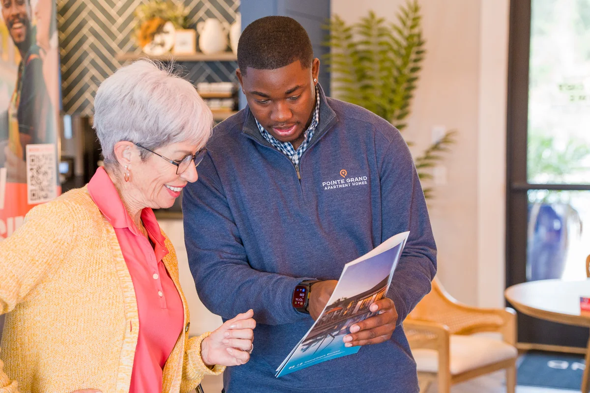 A leasing team member welcoming residents at a Pointe Grand community