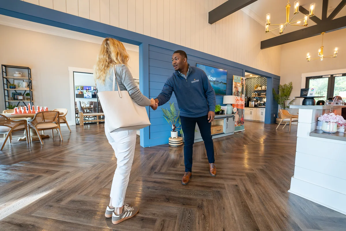 A leasing team member welcoming residents at a Pointe Grand community