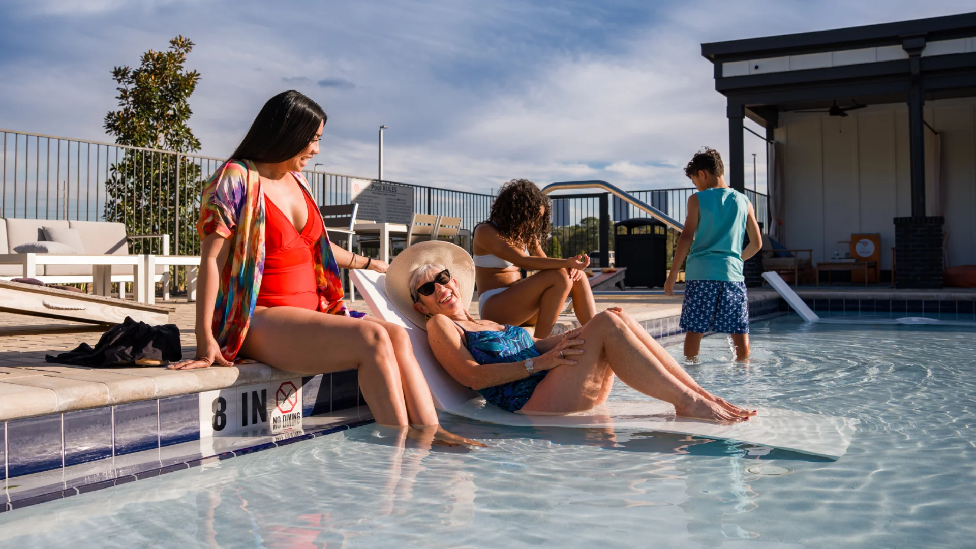 Residents at the pool at a Pointe Grand community